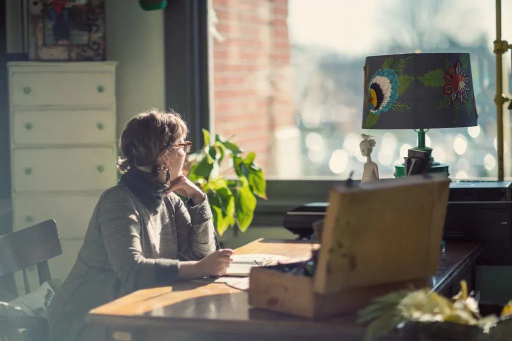 Kelly Rae Roberts' art studio with creative desk arrangement